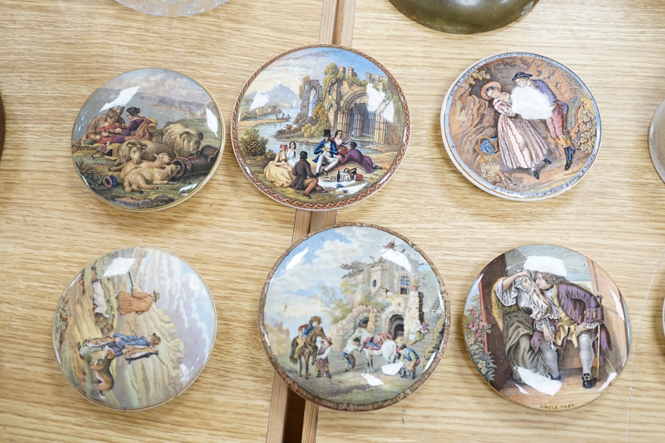 A collection of sixteen mainly 19th century Prattware pomade pot lids